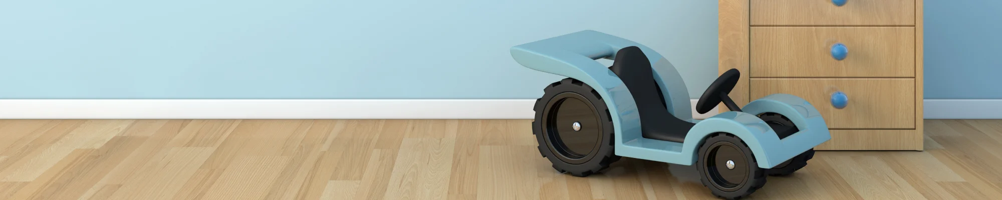 blue toy car, beside a child's dresser, on wood flooring