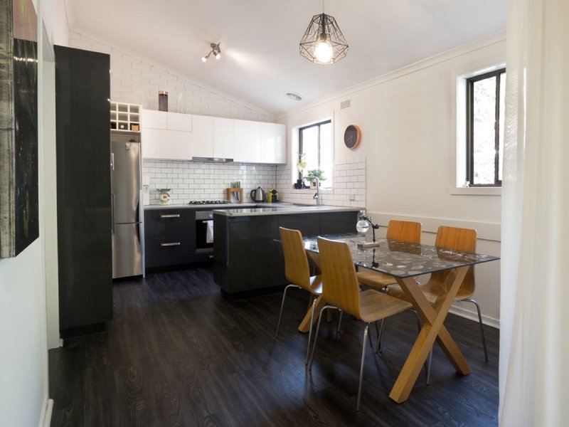 glass dining in small modern kitchen with vinyl floors