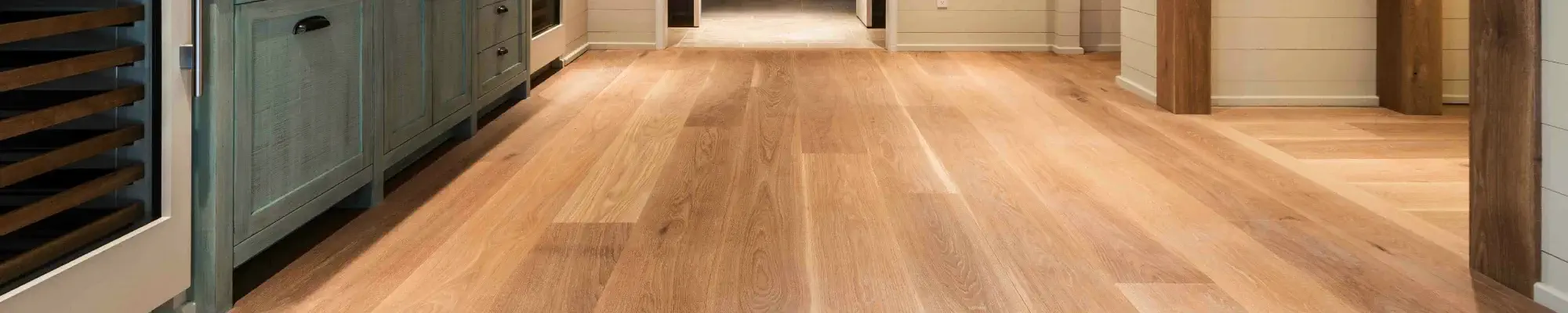 Elegant hardwood floors in rustic kitchen with green cabinets